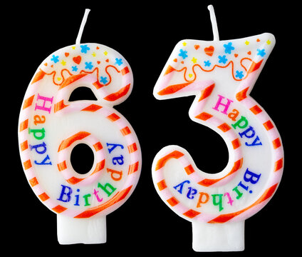 Number sixty three shaped birthday candle with colorful sprinkles and Happy Birthday text isolated on a black background