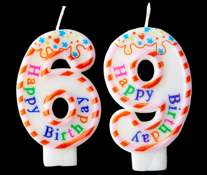 Number sixty nine shaped birthday candle with colorful sprinkles and Happy Birthday text isolated on a black background