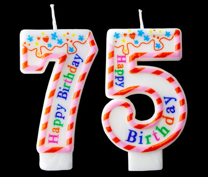 Number seventy five shaped birthday candle with colorful sprinkles and Happy Birthday text isolated on a black background
