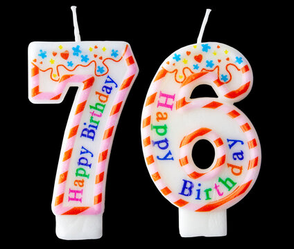 Number seventy six shaped birthday candle with colorful sprinkles and Happy Birthday text isolated on a black background