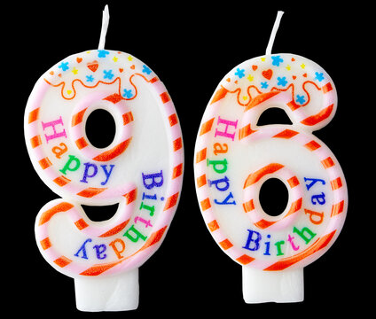 Number ninety-six shaped birthday candle with colorful sprinkles and Happy Birthday text isolated on a black background