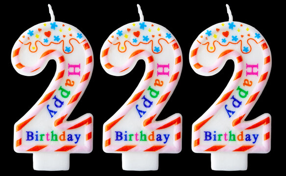Number two hundred twenty-two shaped birthday candles with colorful sprinkles and Happy Birthday text isolated on a black background