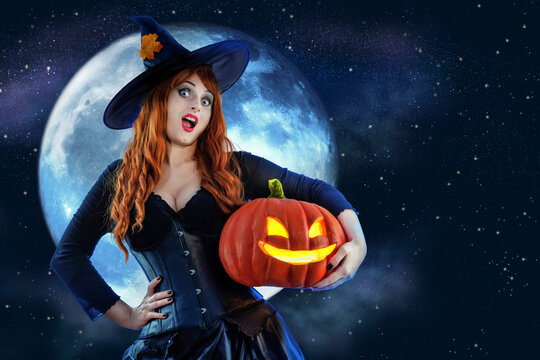 Witch on Halloween. Female wizard fairy character for All Saints' Day. Fantasy gothic red-haired Vampire girl in black dress. Enchantress dressed in carnival costume