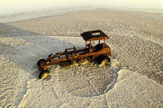 Aerial view of a rusted motor grader abandoned on the salt crust of Lake Tyrrell in Buloke Shire, Victoria, Australia.