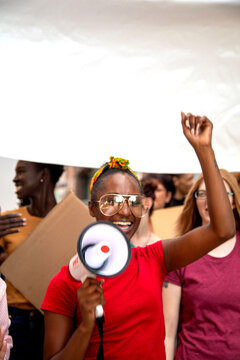 African American woman protesting with megaphone and raised fist