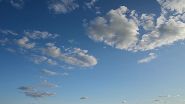 timelapse of a rounded cloud floating in a clear blue sky