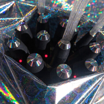 A close-up of a high-speed fiber-optic junction box wrapped in a shimmering, protective holographic security shield.  