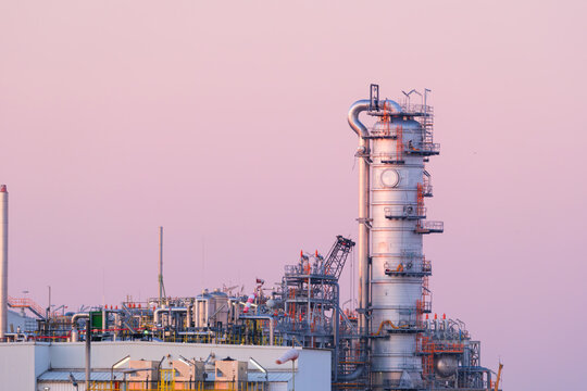 Industrial pipes and equipment at an oil refinery plant. Heavy manufacturing infrastructure for petroleum production.