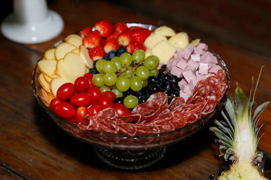Elegant Cheese and Cold Cut Platter on Glass Tray with Grapes and Strawberries
