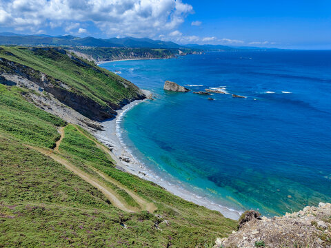 Playa del silencio coastal view with green cliffs
