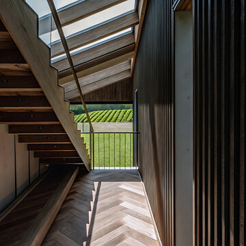 Architectural interior photograph featuring a wooden staircase herringbone floor and scenic outdoor view architecture stairs