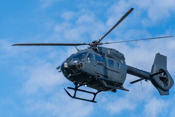 Fototapeta premium Black modern military transport helicopter flying over Budapest, Hungary
