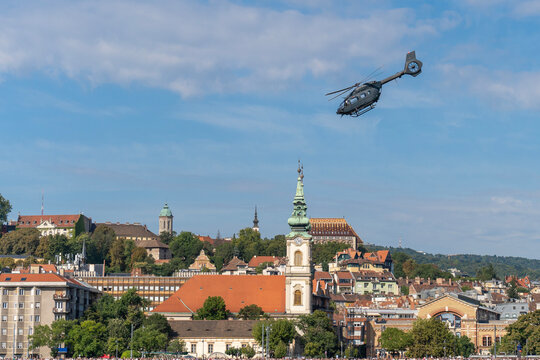 Black modern military transport helicopter flying over Budapest, Hungary