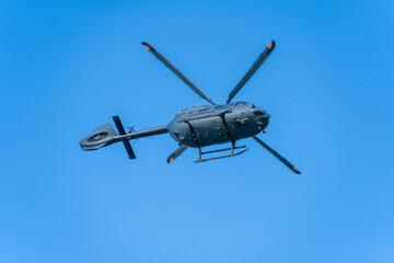 Fototapeta premium Black modern military transport helicopter flying over Budapest, Hungary