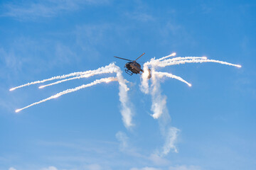 Black modern military transport helicopter shrouded in smoke over Budapest © ZenitX