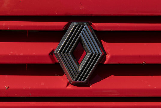 Tavernes Blanques, Spain - June 14, 2026. Detail shot of the Renault diamond badge logo on a red front grille in clear daylight