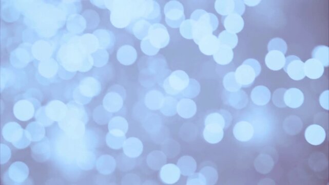 Glowing soft blue bokeh circles floating in a gentle rhythmic motion for digital background video footage