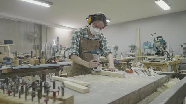 A skilled woodworker is focused on crafting a handmade piece in a well-equipped workshop. Tools and materials are organized around, showcasing craftsmanship and dedication to woodworking.
