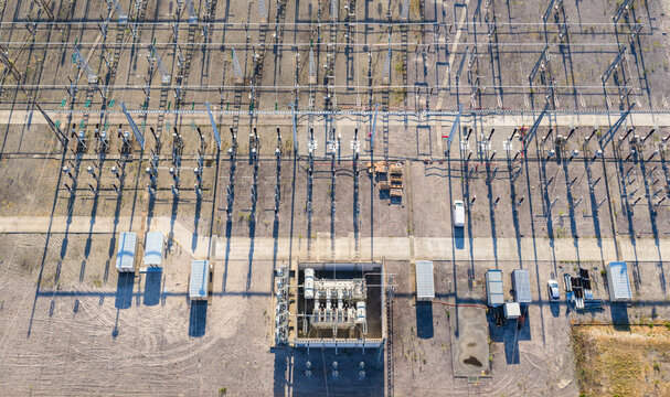Aerial view of a high voltage electrical substation with switching equipment, insulators, and conductors creating a geometric pattern Saulce-sur-Rhone, Auvergne-Rhone-Alpes, France.