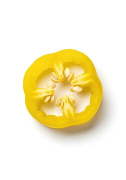 A single round slice of bright yellow pickled banana pepper with visible seeds, isolated on a clean white background for food photography, seed, closeup, vegan