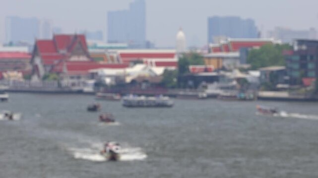 Bokeh view of ferry boats sailing on the Chao Phraya River, Bangkok, Thailand. Blurred background footage.