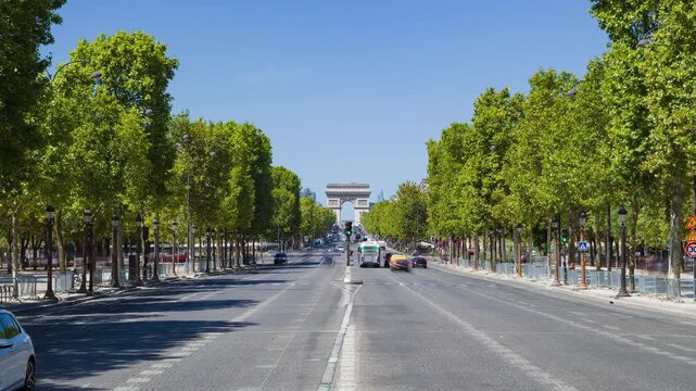 Champs &Eacute;lys&eacute;es Boulevard in Paris with views of Arc de Triomphe, green trees and cars in moving time-lapse - street with dense traffic. Concept of smart city, travel and public transportation, France