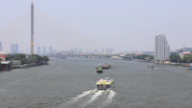 Bokeh view of ferry boats sailing on the Chao Phraya River, Bangkok, Thailand. Blurred background footage.