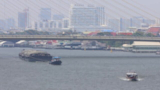 Bokeh view of ferry boats sailing on the Chao Phraya River, Bangkok, Thailand. Blurred background footage.