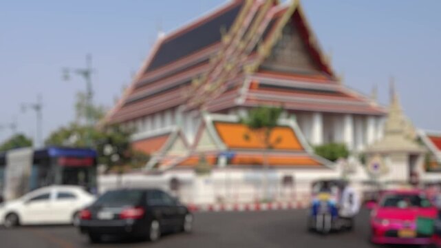 Bokeh view of road traffic near Wat Phra Chetuphon (locally known as Wat Pho), Bangkok, Thailand. Blurred background footage.
