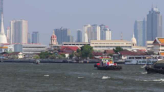 Bokeh view of ferry boats sailing on the Chao Phraya River, Bangkok, Thailand. Blurred background footage.