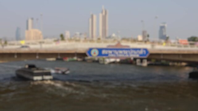 Bokeh view of ferry boats sailing on the Chao Phraya River, Bangkok, Thailand. Blurred background footage.