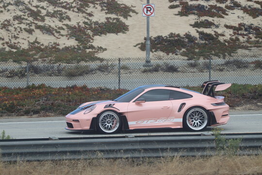 Monterey, California, USA - August 14, 2026: Porsche 911 GT3 RS sports car driving on the highway during Monterey Car Week