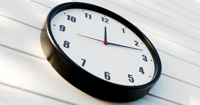 Low angle view of modern 3D wall clock on wooden panel with moving shadows in bright daytime