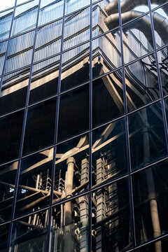Reflections on a contemporary building facade showing glass windows and urban city architecture exterior