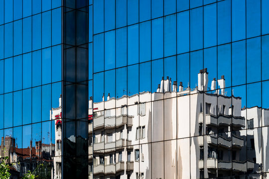 Reflections on a contemporary building facade showing glass windows and urban city architecture exterior