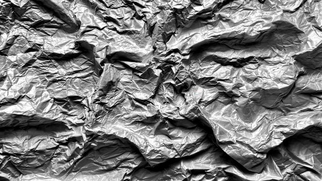 crumpled aluminum foil texture reflecting dramatic silver light as abstract backdrop in packaging and web design
