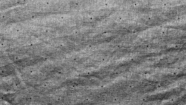 textured grayscale fabric with black dot pattern for grunge background, web design or vintage poster overlay