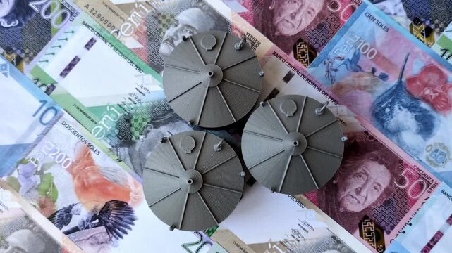 Liquefied gas storage tanks set against the Peruvian money as a background for your design