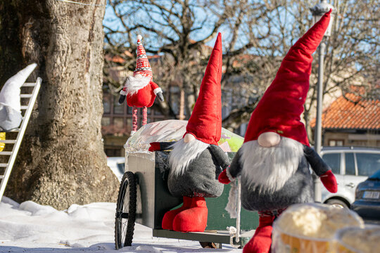 Nordic nisse figurines on cart in winter square The Concept of Christmas decoration