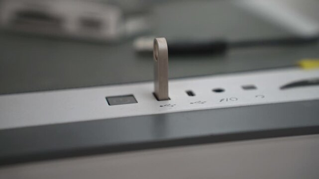 Man inserting an Usb flash drive in to a personal computer.