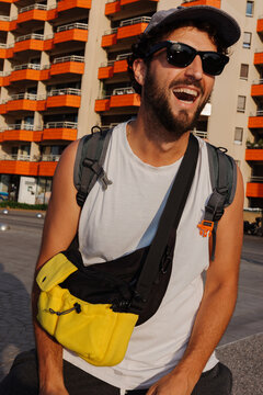 Man smiles and enjoys time outdoors near buildings in the city