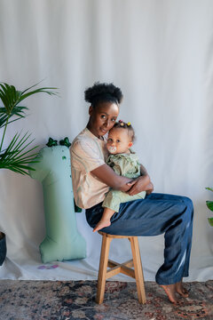 Mother posing with her baby near one year balloon 