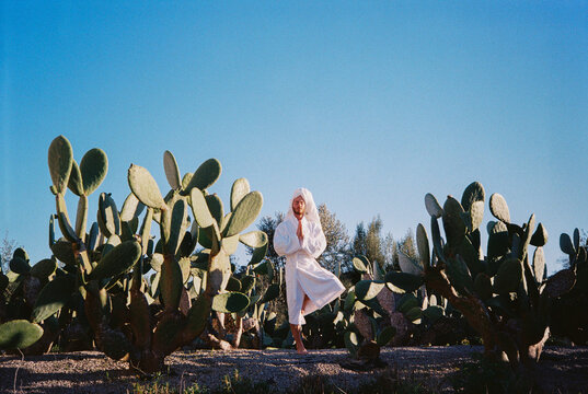 Film Picture of Man Doing a Silly Meditation Pose Among Cactus
