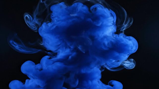 Blue Ink Droplets Dissolving in Water Creating Abstract Smoke Patterns