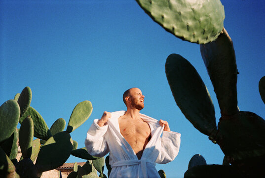 Aggressive Man Shouting Among Cacti Under Blue Sky