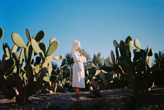 Film Picture of Woman Doing a Meditation Pose Among Cactus