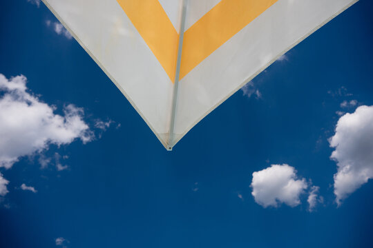 Looking Up at Sun Shade Against Blue Summer Sky