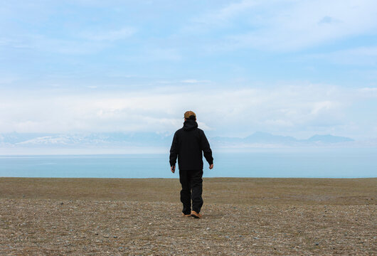A Traveler Strolling Along the Shore of Sayram Lake.