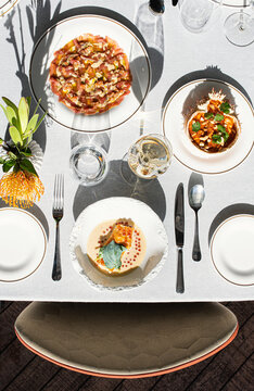 Fine dining table setting with multiple plated gourmet dishes