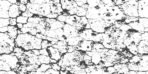 Fototapeta premium Cracked dry earth texture with deep fissures and rough surface under stark lighting creating a distressed abstract backdrop